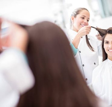 Beautiful woman at the hair salon cutting her hair very short